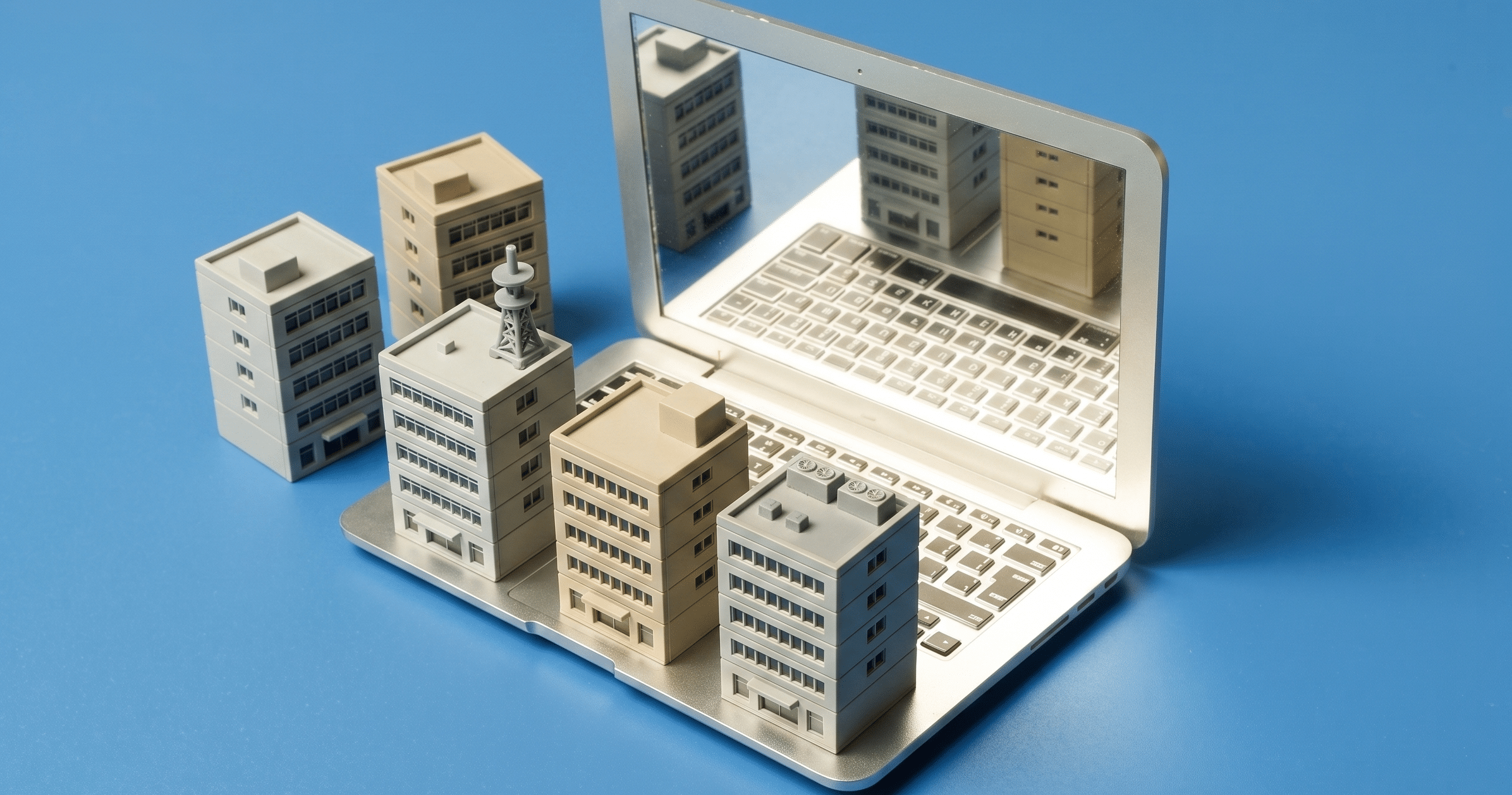 Portada maqueta edificios pequeños sobre ordenador portatil
